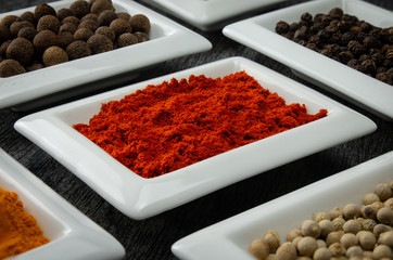 Paprika powder. Colorful spices in white bowls Seasonings for cooking. Natural Herbs & Spices.