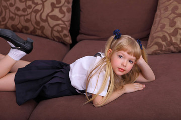 Nice cute sweet tender cheerful positive small little girl with curly pony-tails in white formal shirt and blue skirt asian schoolgirl