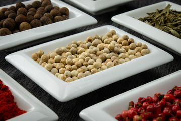 White pepper. Colorful spices in white bowls Seasonings for cooking. Natural Herbs & Spices.