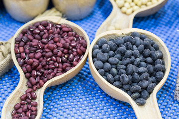 Black beans and azuki beans on blue background.