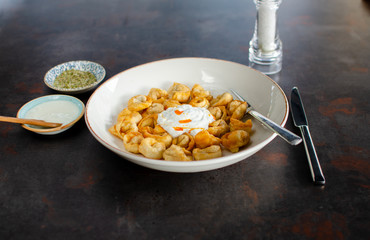 Homemade delicious turkish manti ( turkish ravioli ) with yogurt and sauce. stock photo