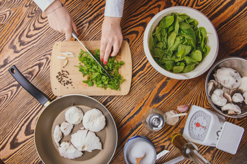 composition poured olive oil, mushrooms, garlic on wooden background