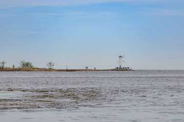 Old lighthouse in Swinoujscie, a port in Poland on the Baltic Sea. The lighthouse was designed as a traditional windmill. Panoramic image.