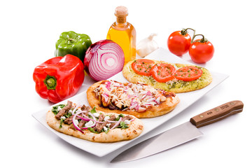 Various Pizzas on White Plate on White Background with Ingredients