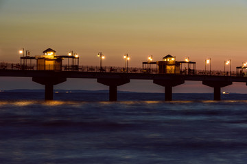 Baltic sea at beautiful sunset in Miedzyzdroje beach. Polish baltic coast. Famous city among the tourist. Pier at sunset