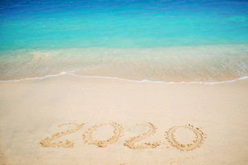 New 2020 year in the South, the sea. Sea surf. Blue wave is coming ashore. Inscription on sand,