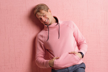 Happy and smiling young man in casual clothes looks at the camera, portrait with real emotions