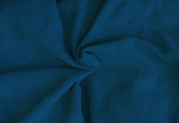 Crumpled blue fabric texture close up. Trendy tone of 2020 classic blue color