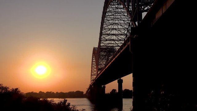Sunset at the Hernando de Soto Bridge crossing the Mississippi River in Memphis, Tennessee.