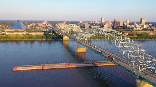 Good aerial over the Hernando de Soto Bridge Mississippi River and barge revealing Memphis, Tennessee.