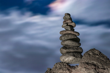 Object of stones on the background of the night sky and the moon. Zen stones. Harmony & Meditation