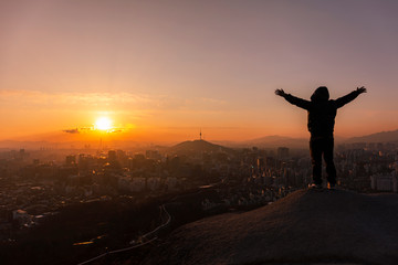 silhouette of man on top of mountain