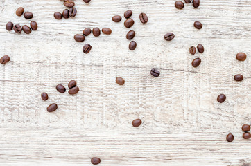 Roasted coffee beans on wooden texture background.