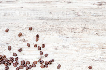 Roasted coffee beans on wooden texture background.