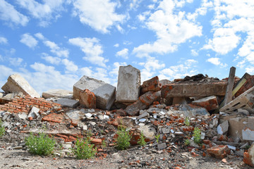 Fototapeta na wymiar Concrete slabs are piled into the heap after the destruction of the building.