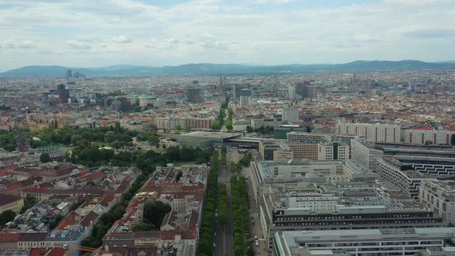 flight over vienna city sunny day traffic street train station district aerial panorama 4k austria