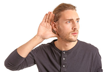 Young man with hearing problem on white background