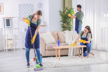 Team of janitors cleaning room