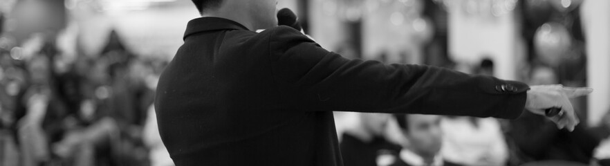 Speech given by professional speaker on stage at corporate conference. Executive manager giving...