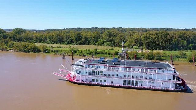 Beautiful aerial shot of a paddlewheel steamboat luxury cruise ship on the Mississippi River near West Helena, Arkansas.