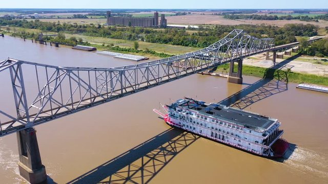 Beautiful aerial shot of a paddlewheel steamboat luxury cruise ship on the Mississippi River near West Helena, Arkansas.