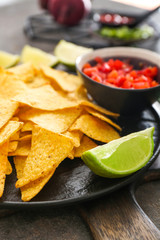 Tasty nachos on plate, closeup