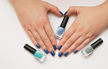 Female hand with trendy manicure in classic blue color. Color of the year 2020.