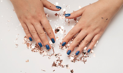 Female hand with trendy manicure in classic blue color. Color of the year 2020. - obrazy, fototapety, plakaty