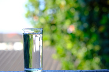 glasses of  water on green background