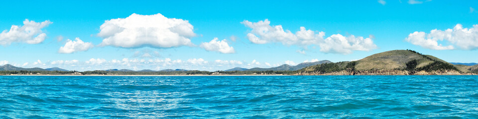 Fototapeta na wymiar Coastal ocean sky art image. White super panorama Cumulus cloudscape in blue sky. Australia.
