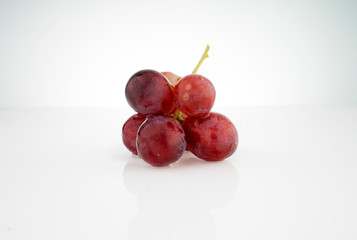 Red grape isolated on white background.