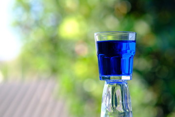glass of cocktail on green background