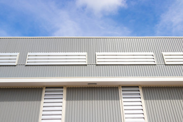 Metal sheet roof and wall steel with louver build factory and warehouse with blue sky.