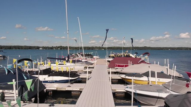 Pantalan of wood in the port where they remain moored amount of boats, the camera lowers slowly while the wind moves the flags