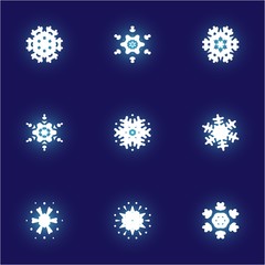 Fototapeta na wymiar Set of isolated falling snowflakes on blue background.