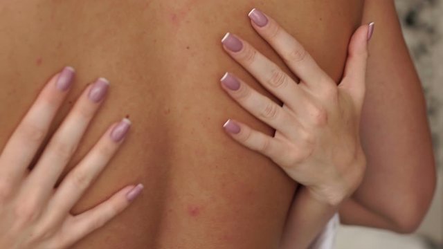 Close-up of a girl passionately embracing her boyfriend behind his naked back, a young couple having sex. Close-up of the girl's hands on the man's back. Sexual relations between a man and a woman.