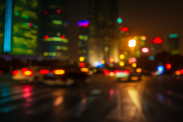 Abstract background of People across the crosswalk at night in Shanghai, China.