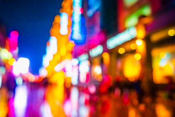 Abstract background of People across the crosswalk at night in Shanghai, China.
