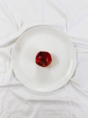 Top shot of pomegranate placed on a plate.