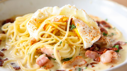 Pasta cream sauce with bacon and poached egg