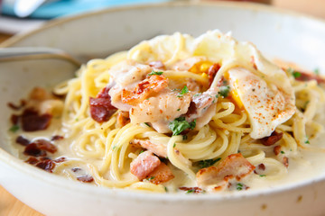 Pasta cream sauce with bacon and poached egg