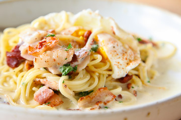 Pasta cream sauce with bacon and poached egg