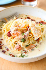 Pasta cream sauce with bacon and poached egg