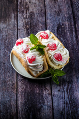 Airy raspberry cake in a plate on a wooden background