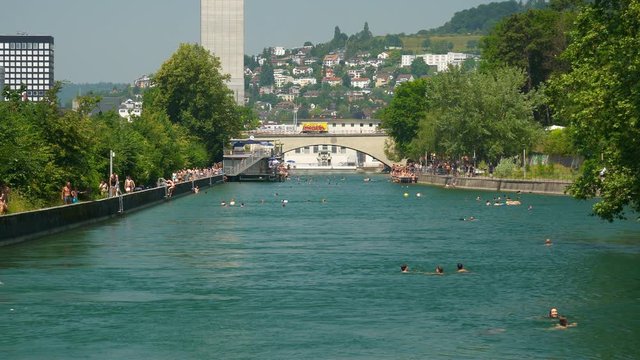 zurich city center sunny summer day crowded river swimming place bridge panorama 4k switzerland
