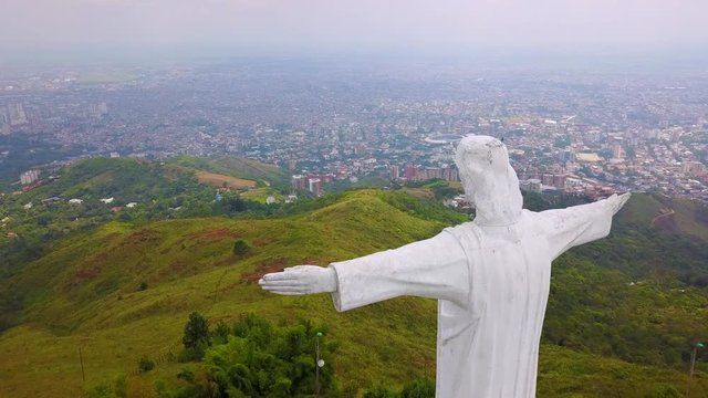 Aerial shot around the Cristo Rey statue in Cali, Colombia.