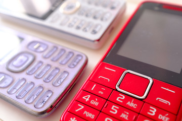 three vintage colorful cell phone display on white table