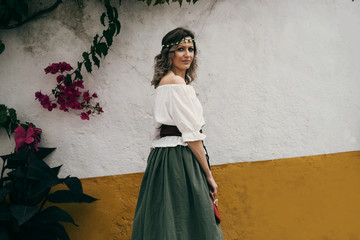 Portrait of woman wearing medieval European maidservant clothes on outdoors. Festival in Óbidos...