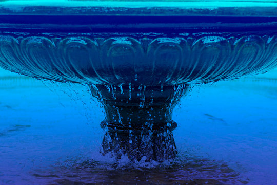 Fountain bowl high shutter speed to freeze water dripple down, blue water. Horizontal. Architecture and decoration. Classic, blue monochrome, trend 2020