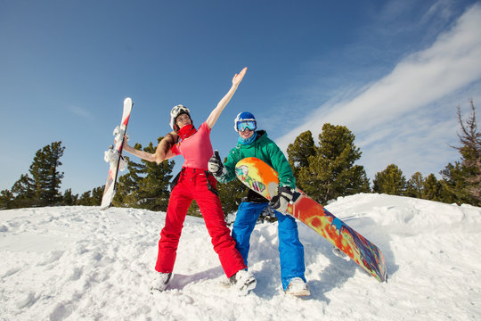  happy friends having fun playing in snow. Ski and snowboard sunny holiday